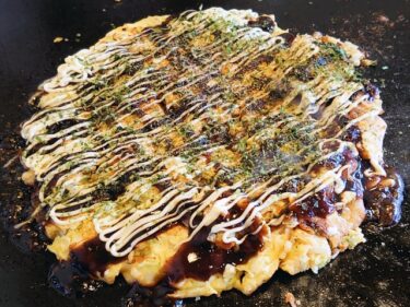 Okonomiyaki, a pancake-like dish with meat and vegetables